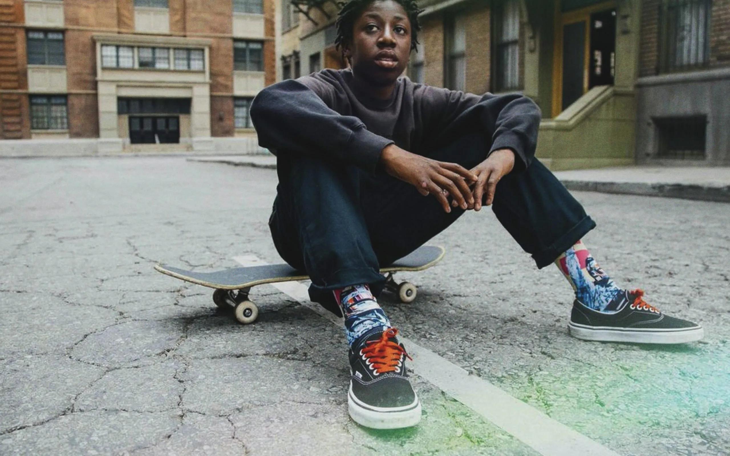 Skater sitting on his skateboard wearing stance socks