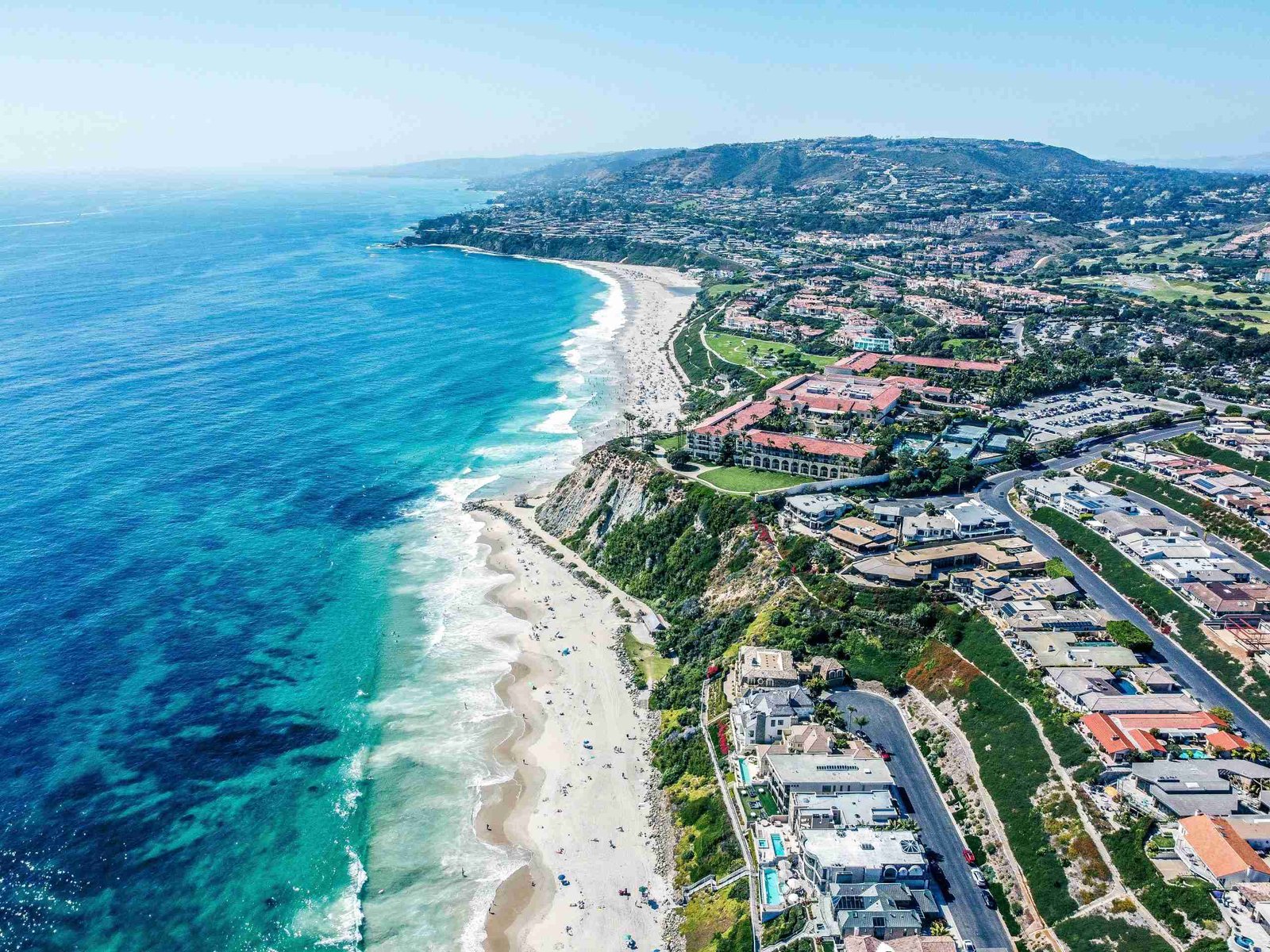 Aerial shot of Orange County with the beach on one side and the city on the other.