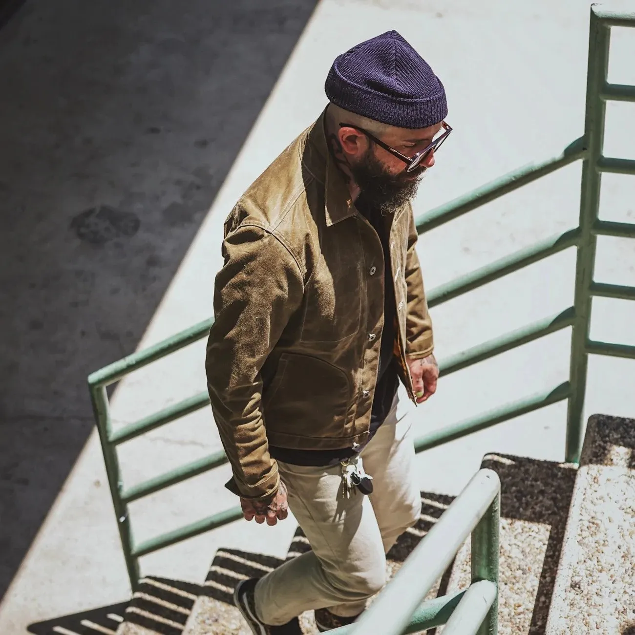 Man walking up stairs wearing Snake Oil Provisions clothing