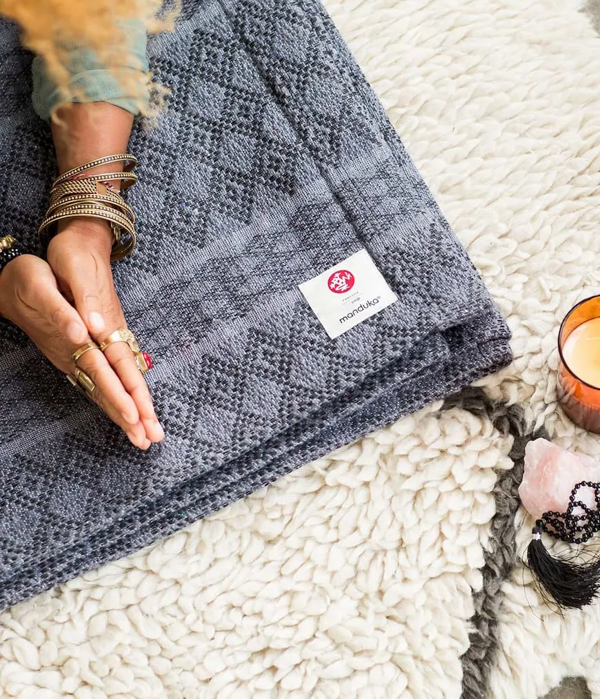 Hands together on a Manduka yoga mat