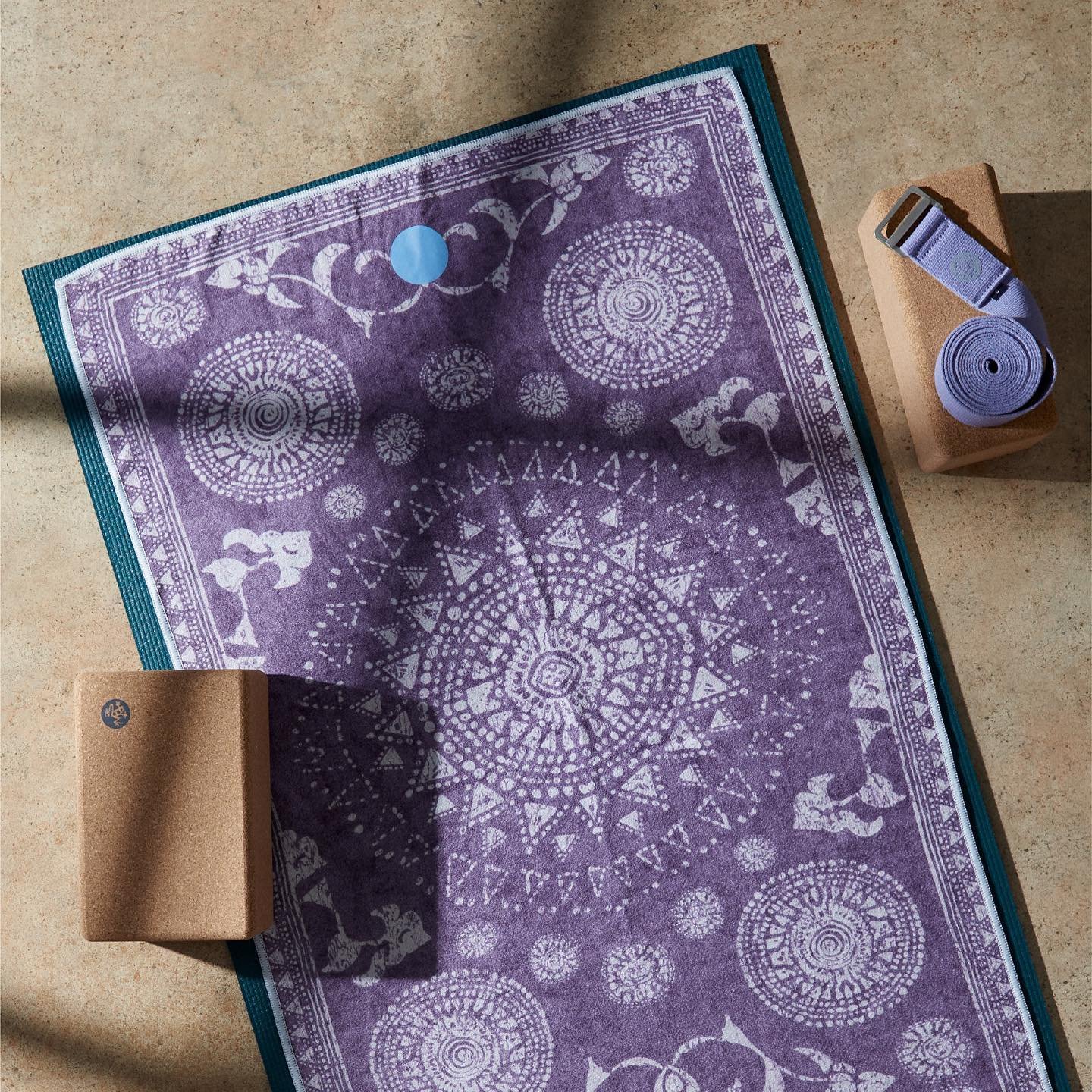 Purple Manduka yoga mat and bricks