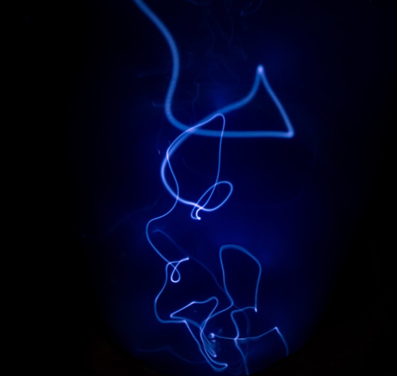 artistic string of blue light shining in the dark