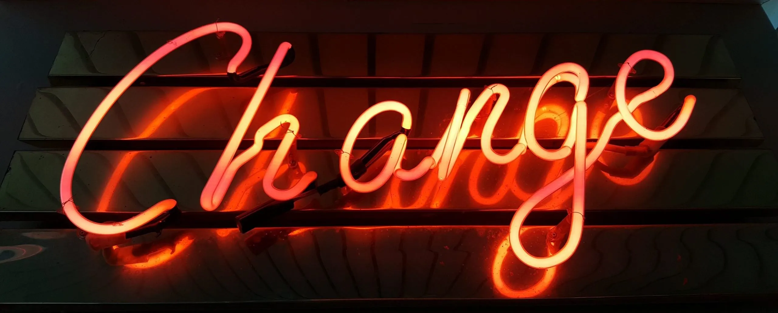 neon sign of the word change