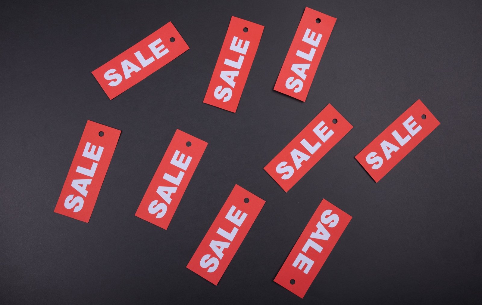 a bunch of price tags advertising a sale scattered around