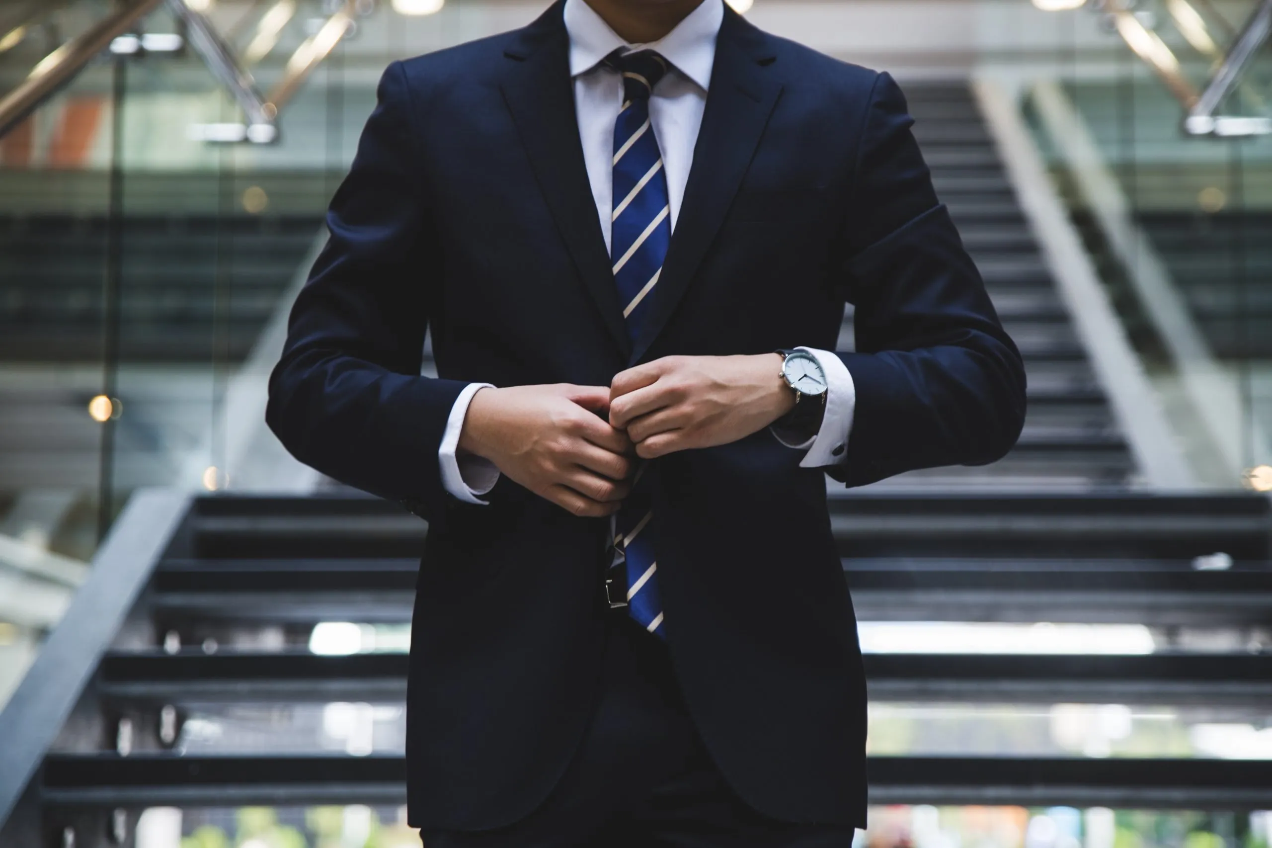 business man buttoning up his suit jacket