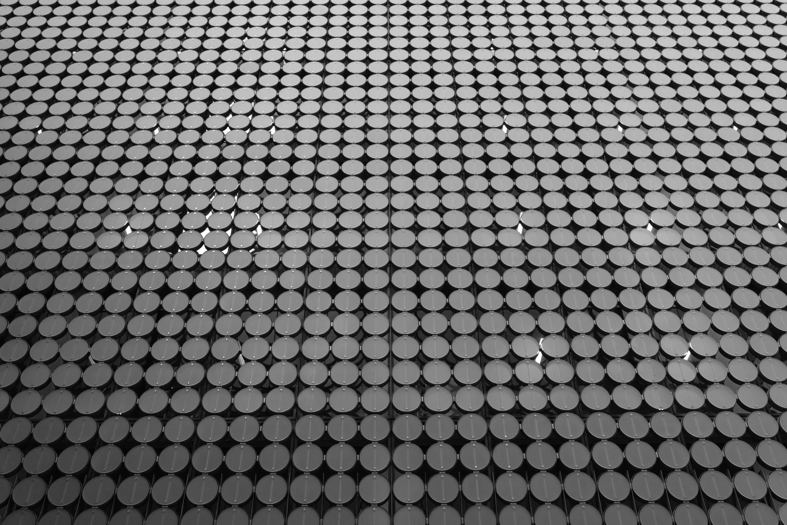 many small metallic circles in an architectural pattern
