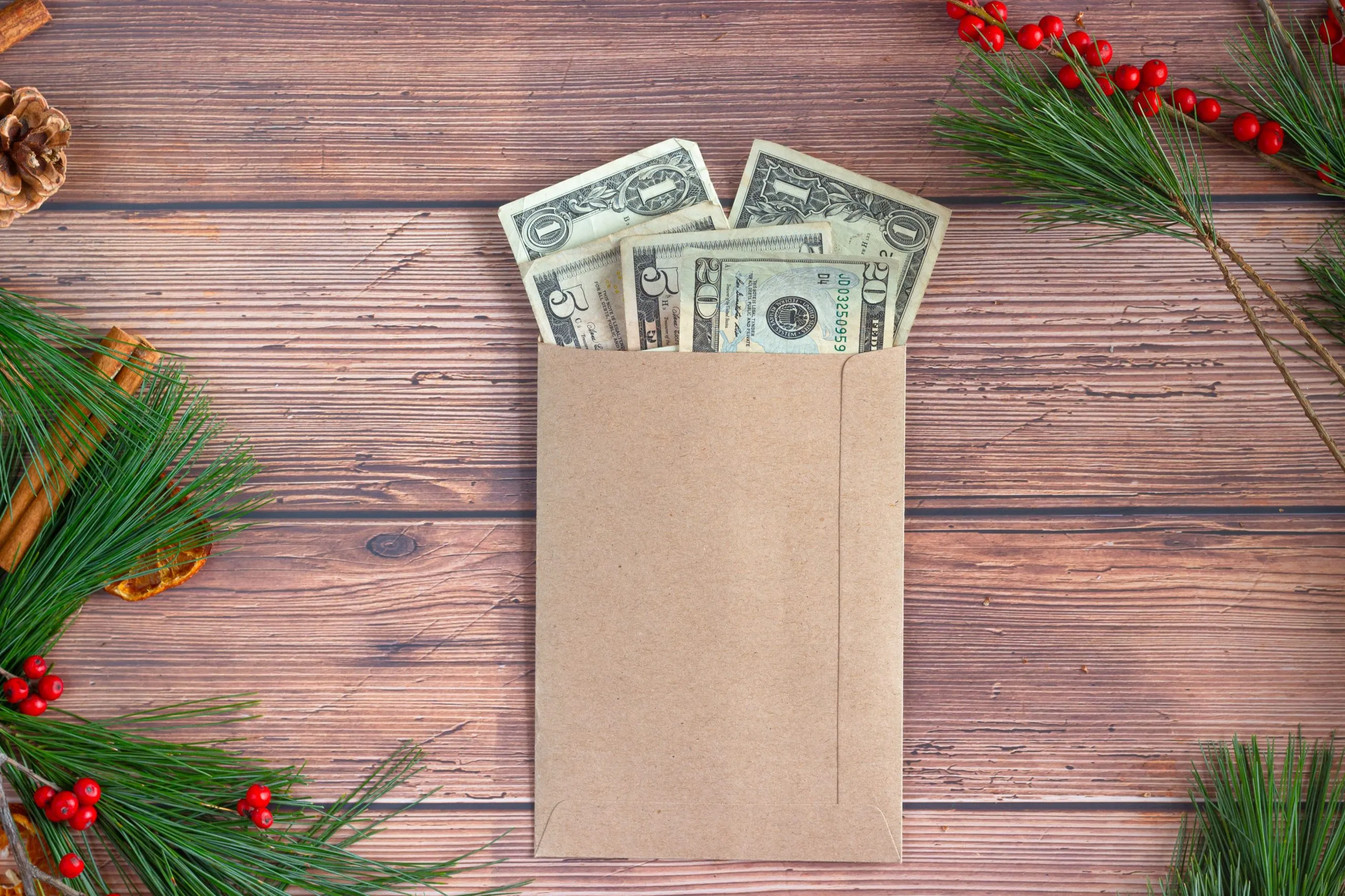 several dollar bills sticking out of an envelope on a table