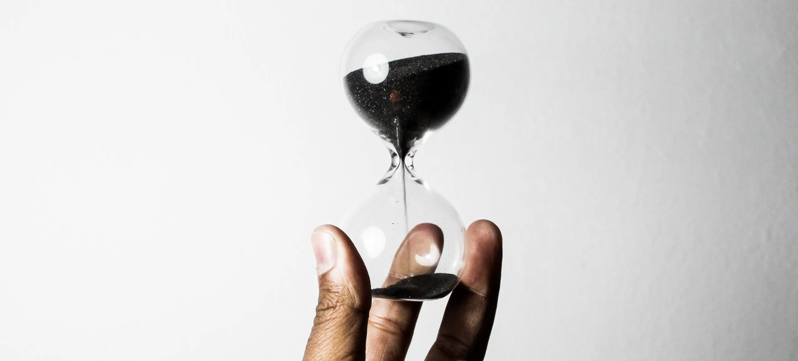 hand holding up an hourglass
