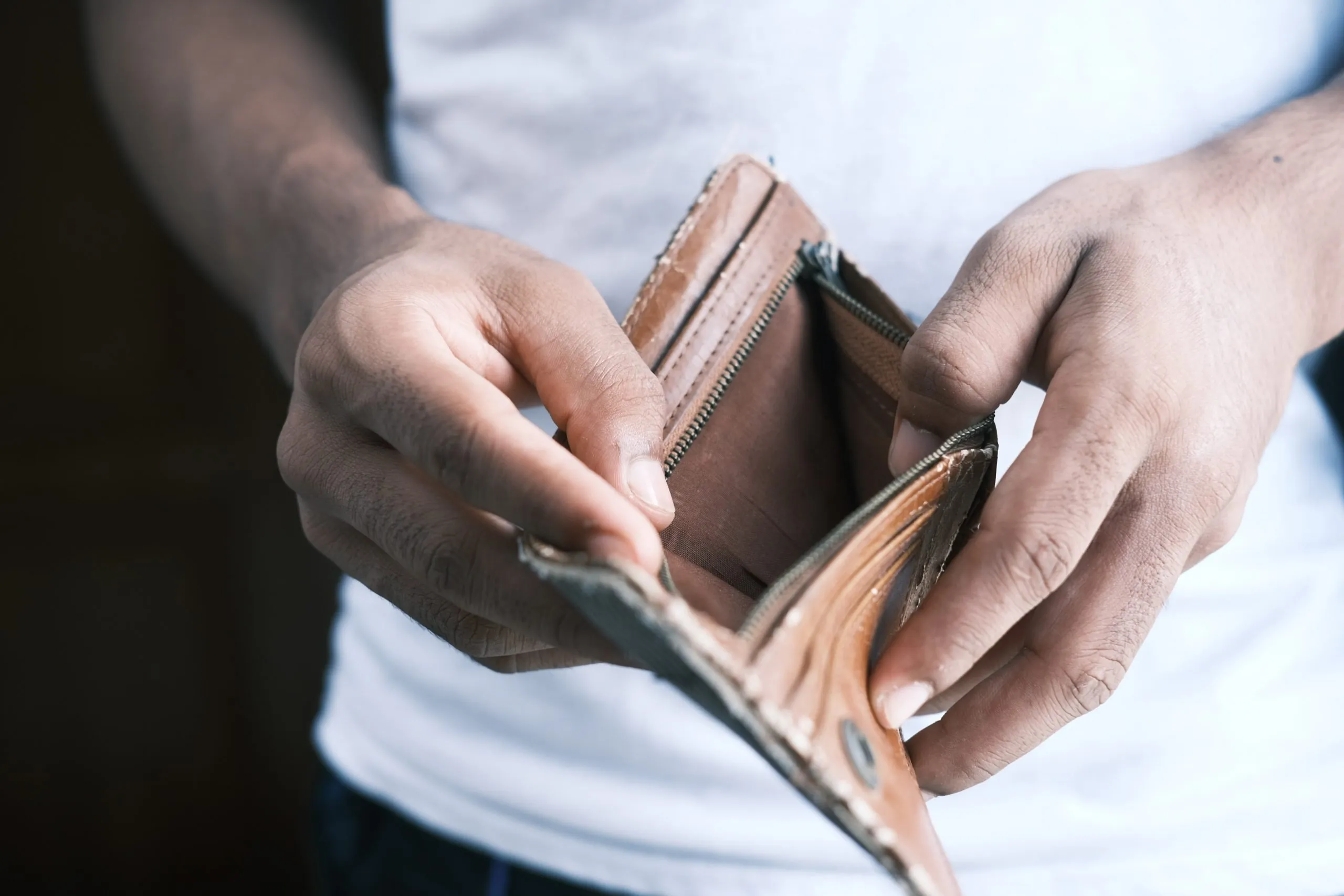 man opening up an empty wallet