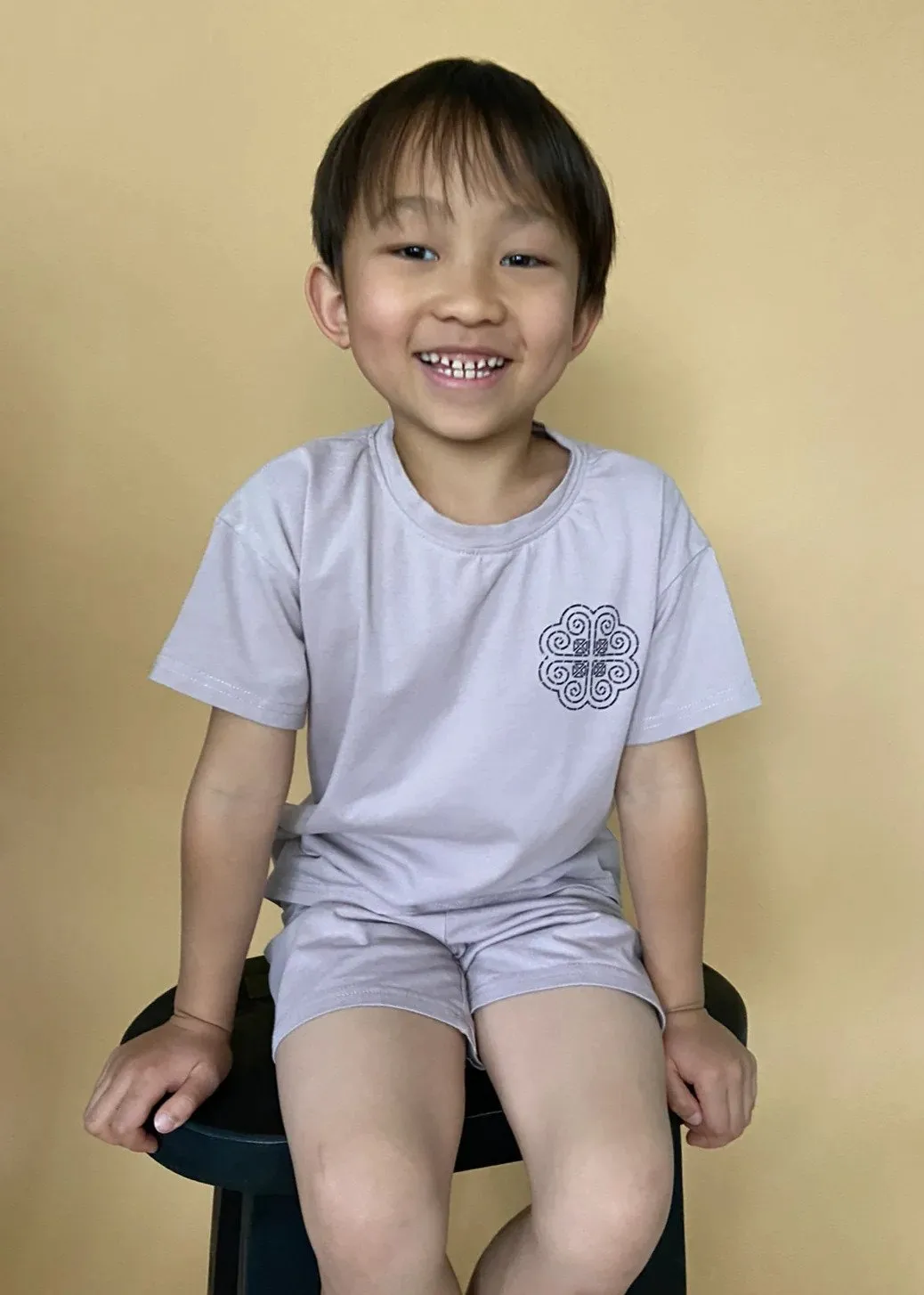 Child wearing TAUPE HMONG LOGO SHIRT SET IN BLACK