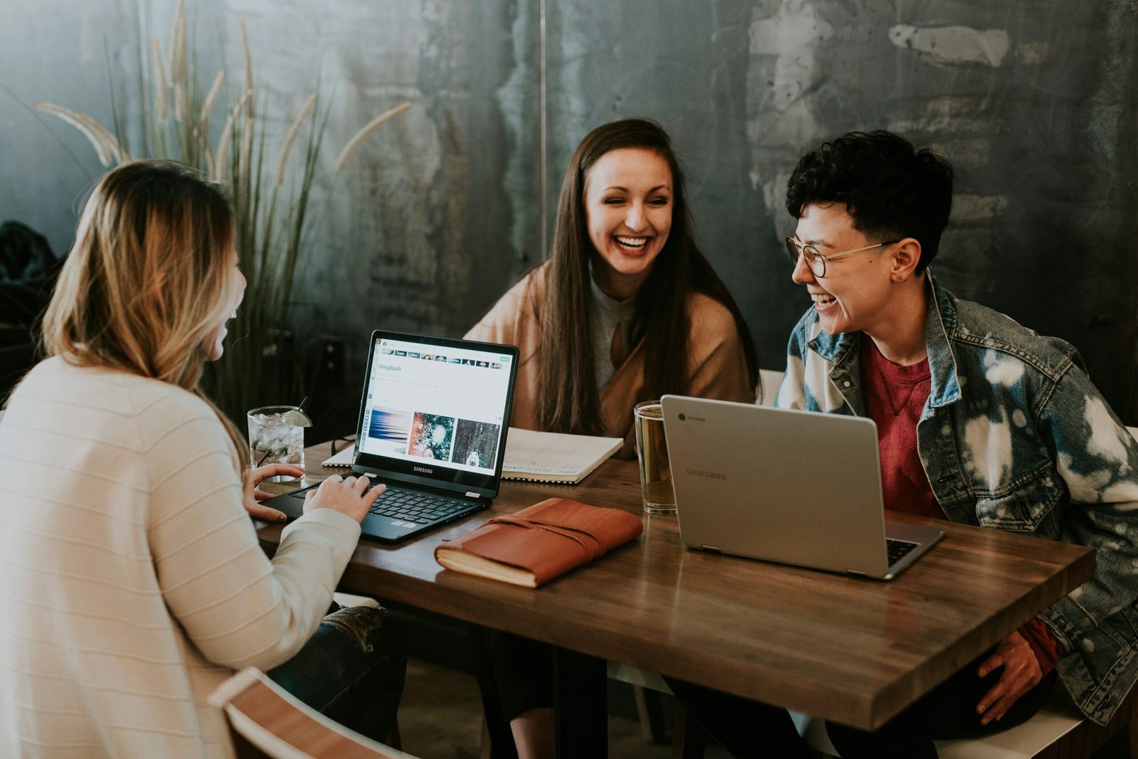 coworkers smiling and laughing at a desk